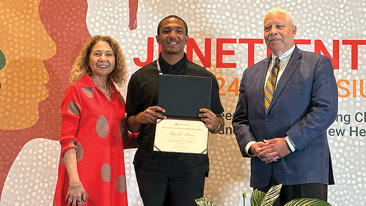 Tajuddin Henry poses with California State University Chancellor Mildred García and Jack Clarke, chair of the CSU Board of Trustees, during the Black Student Success Scholarship ceremony.
